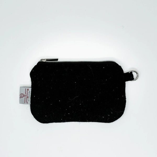 Black Harris Tweed pouch with white nepps handcrafted in Wales, flat lay showing zip closure and D-ring attachment
