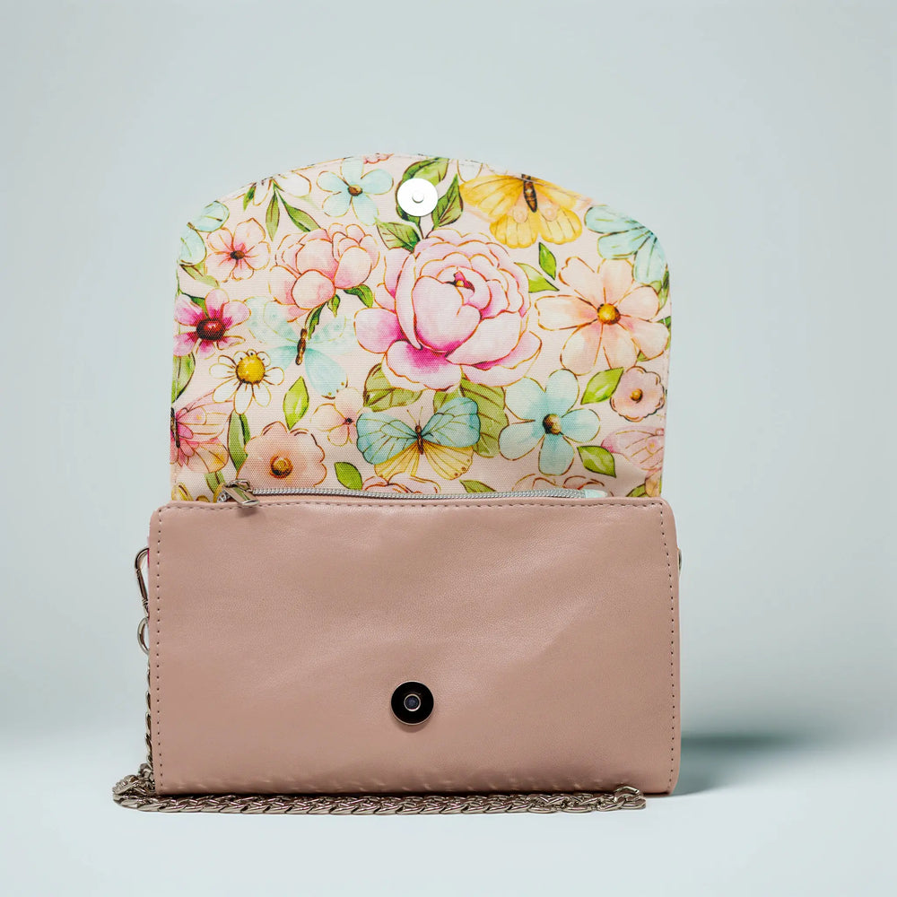 Floral-patterned clutch with a pastel pink leather base by Emma Easter handcrafted