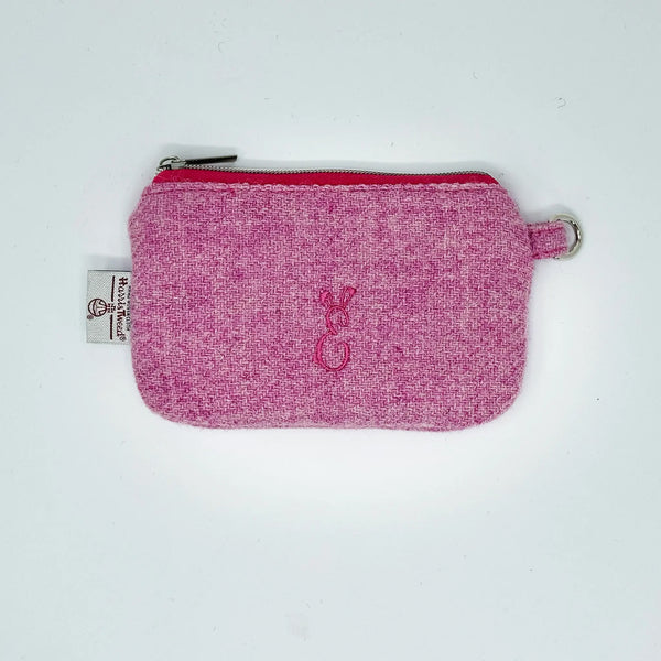 Pink Harris Tweed® pouch with a logo on a white background