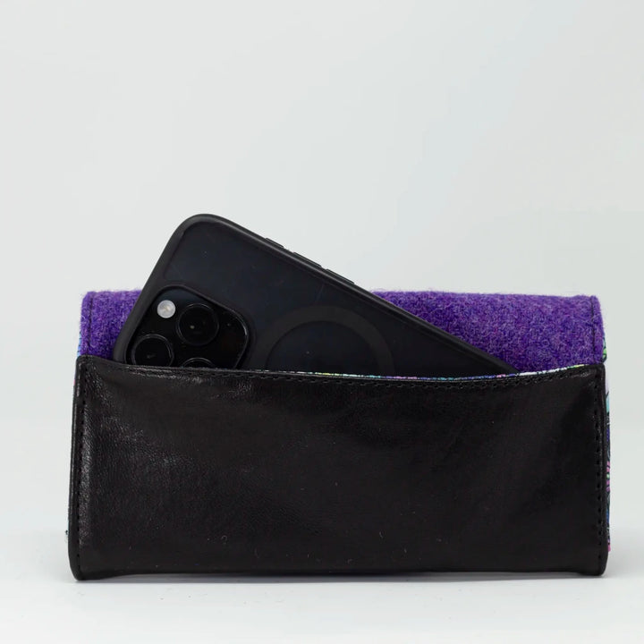 Aurora leather purse shown with smartphone to demonstrate size and capacity