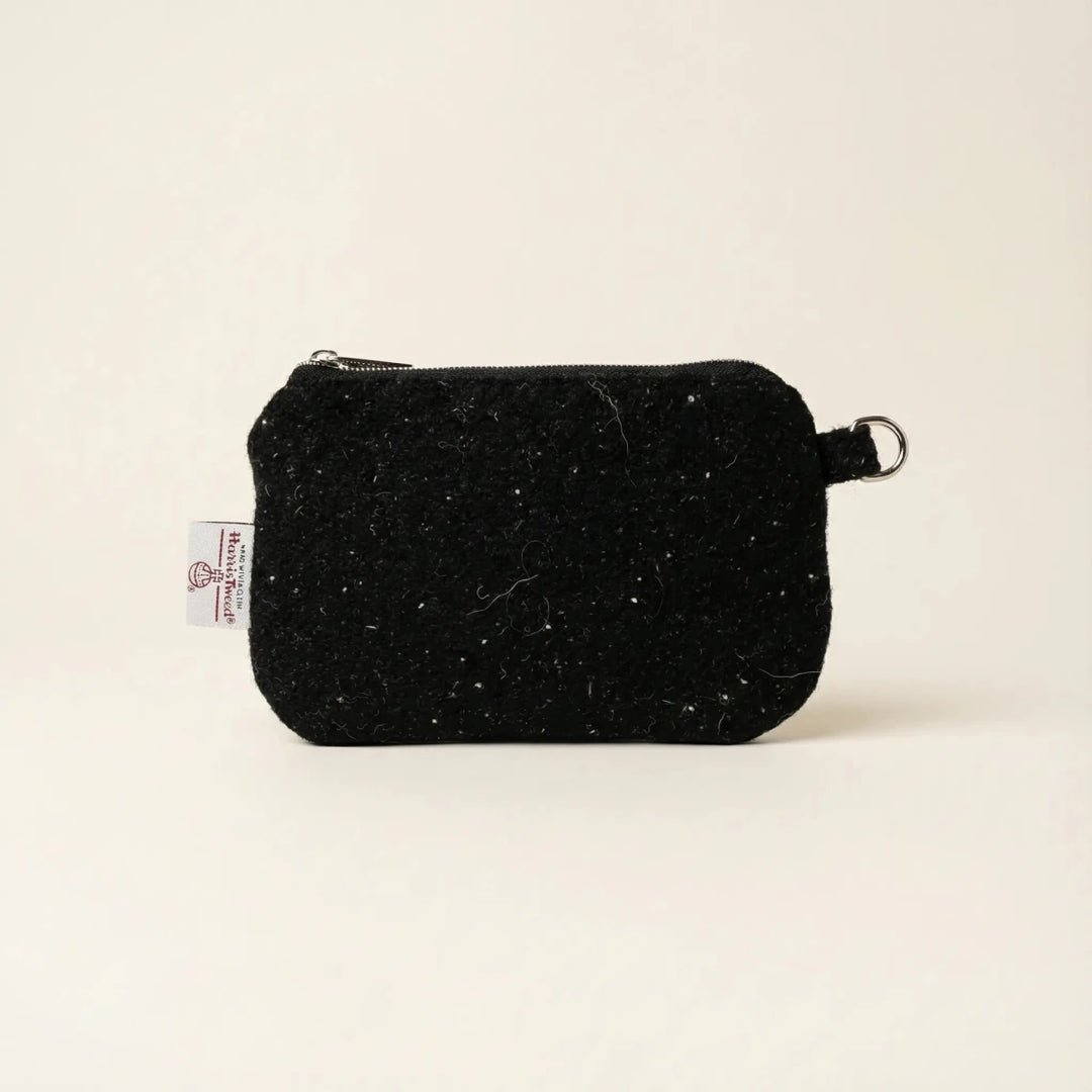 Black Harris Tweed pouch with white nepps handcrafted in Wales, flat lay showing zip closure and D-ring attachment