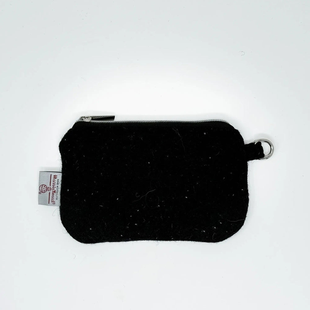 Black Harris Tweed pouch with white nepps handcrafted in Wales, flat lay showing zip closure and D-ring attachment