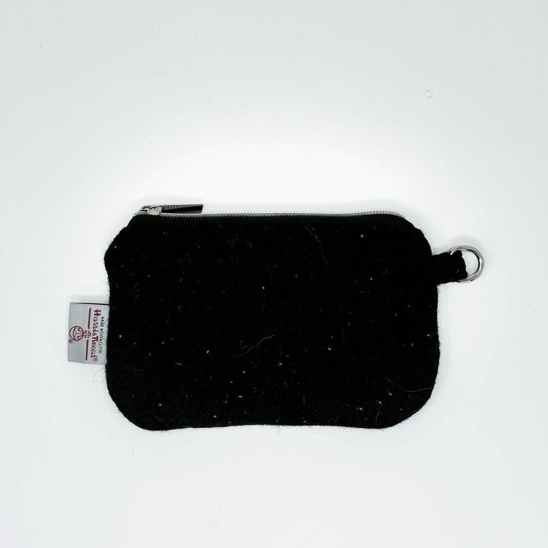 Black Harris Tweed pouch with white nepps handcrafted in Wales, flat lay showing zip closure and D-ring attachment
