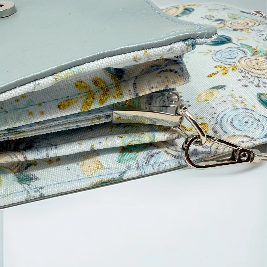 Floral-patterned  leather bag with a silver side connector and removable chain strap made in Wales by Emma Easter handcrafted