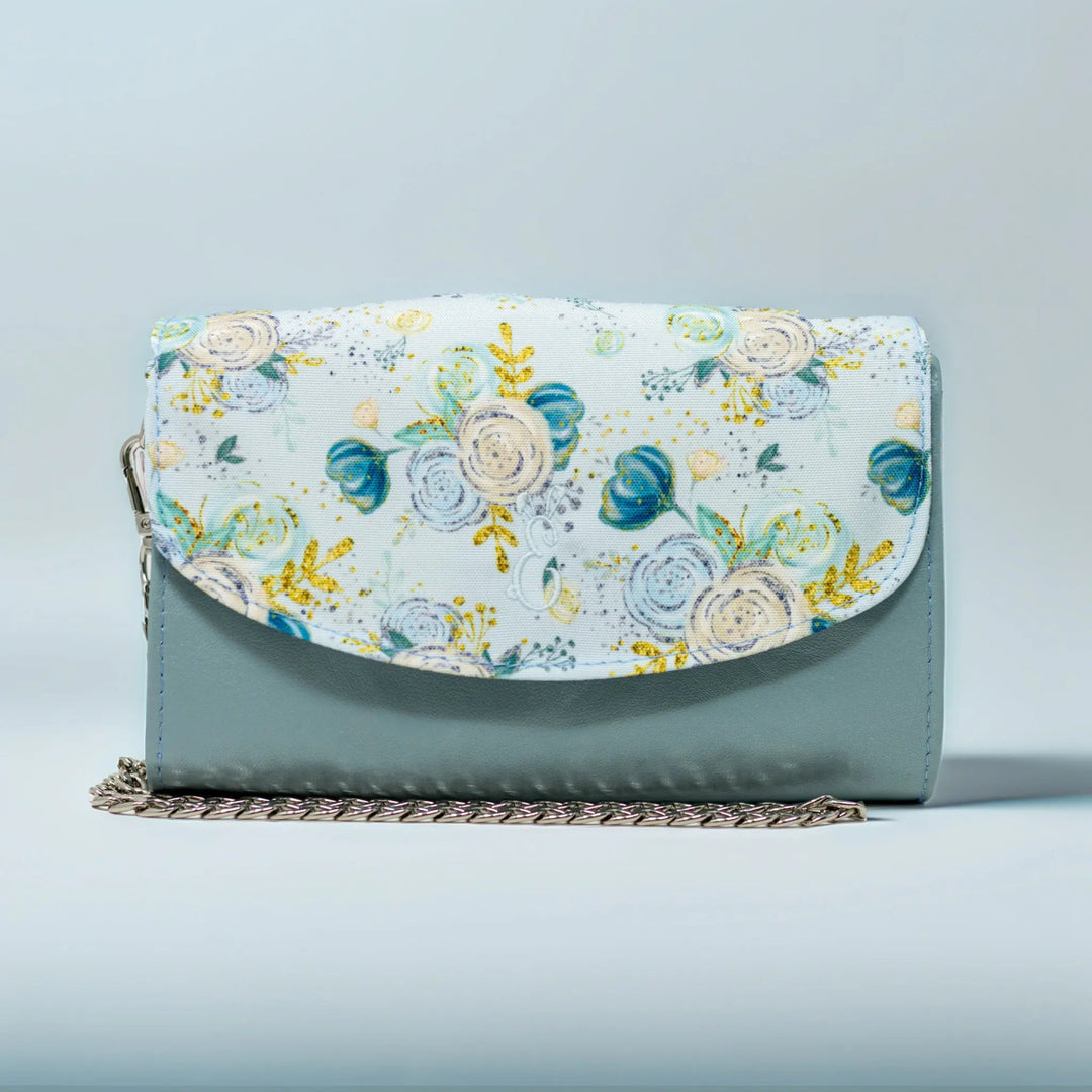 Floral-patterned leather clutch bag with removable crossbody chain strap made in Wales by Emma Easter handcrafted 
