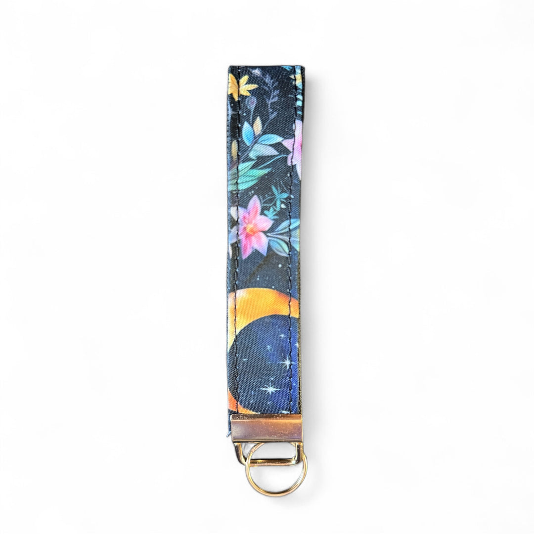 Handcrafted celestial key fob | Emma Easter Handcrafted in Wales | Mystic Garden collection wristlet with moon and floral design on navy background