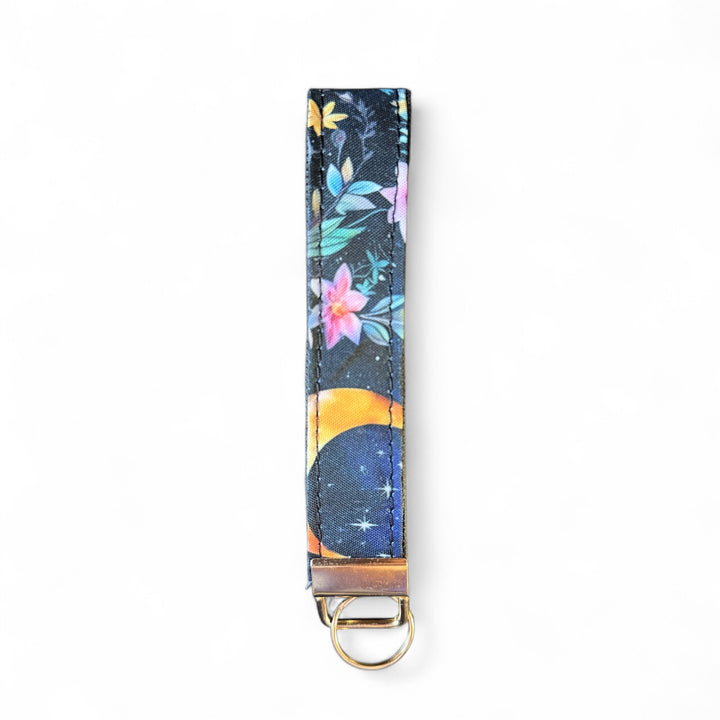 Handcrafted celestial key fob | Emma Easter Handcrafted in Wales | Mystic Garden collection wristlet with moon and floral design on navy background
