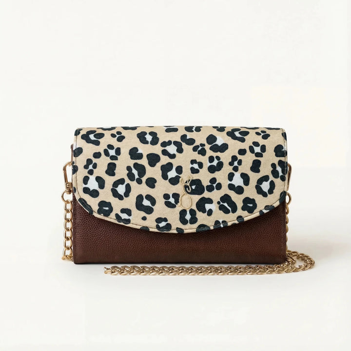 Leopard print Italian leather handbag, with beige and black animal print flap, brown leather body, and gold chain strap.