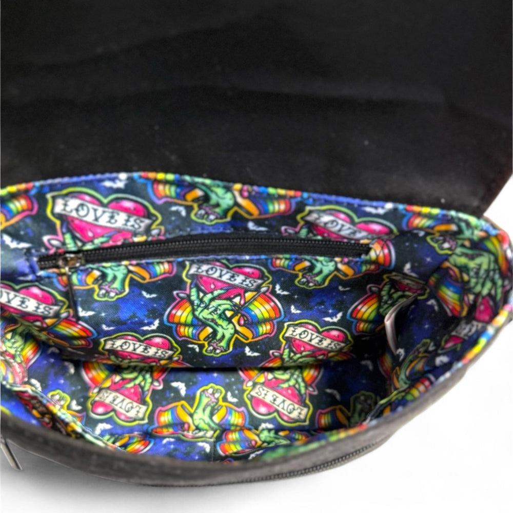 Interior view of Love is Love zombie Pride crossbody bag showing colorful water-resistant lining with rainbow pattern