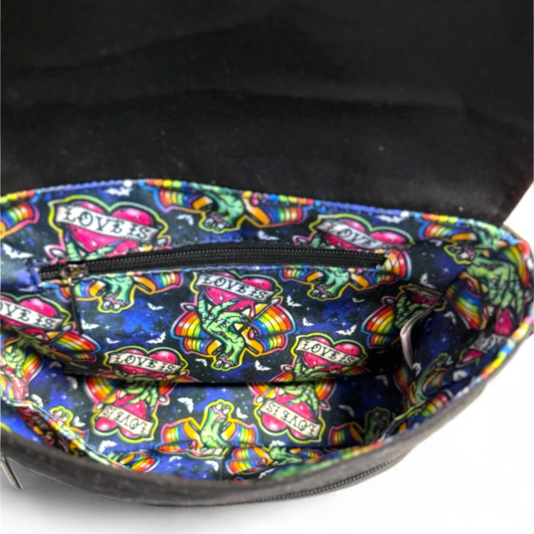 Interior view of Love is Love zombie Pride crossbody bag showing colorful water-resistant lining with rainbow pattern