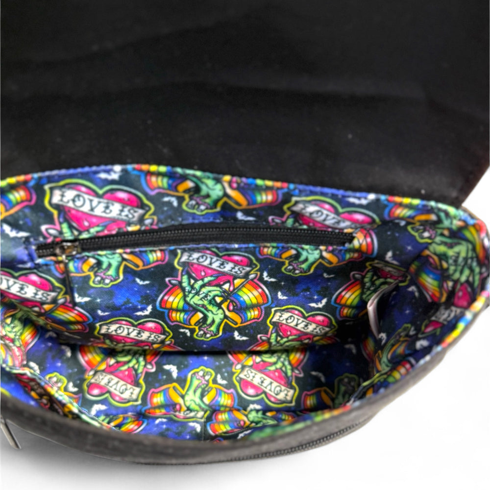 Interior view of Love is Love zombie Pride crossbody bag showing colorful water-resistant lining with rainbow pattern