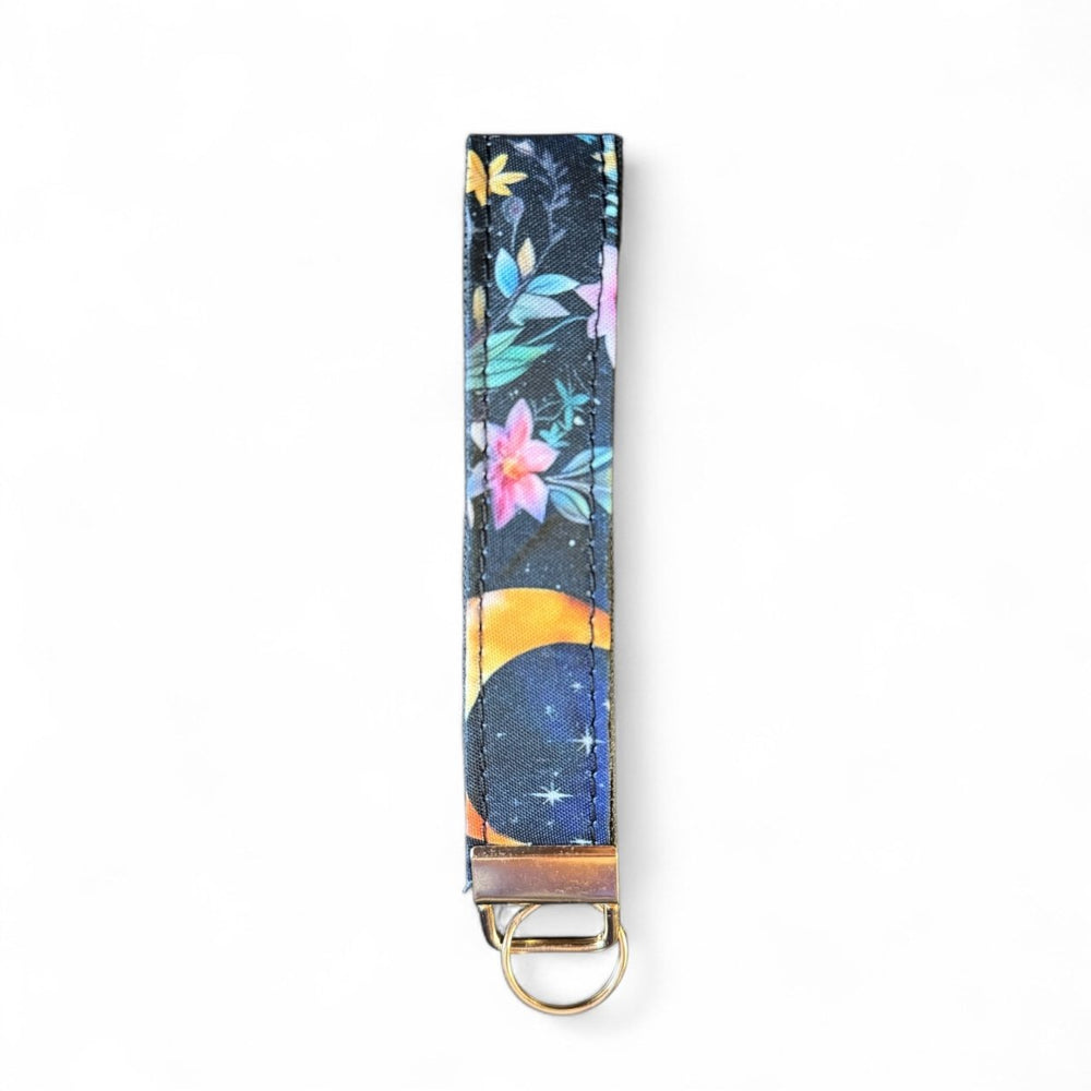 Handcrafted celestial key fob | Emma Easter Handcrafted in Wales | Mystic Garden collection wristlet with moon and floral design on navy background