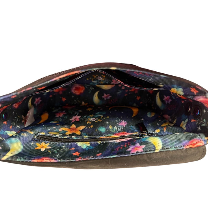 Close-up of inside the Mystic Garden Crossbody featuring a vibrant moon-and-flower-themed lining with divided slip pockets for organisation.
