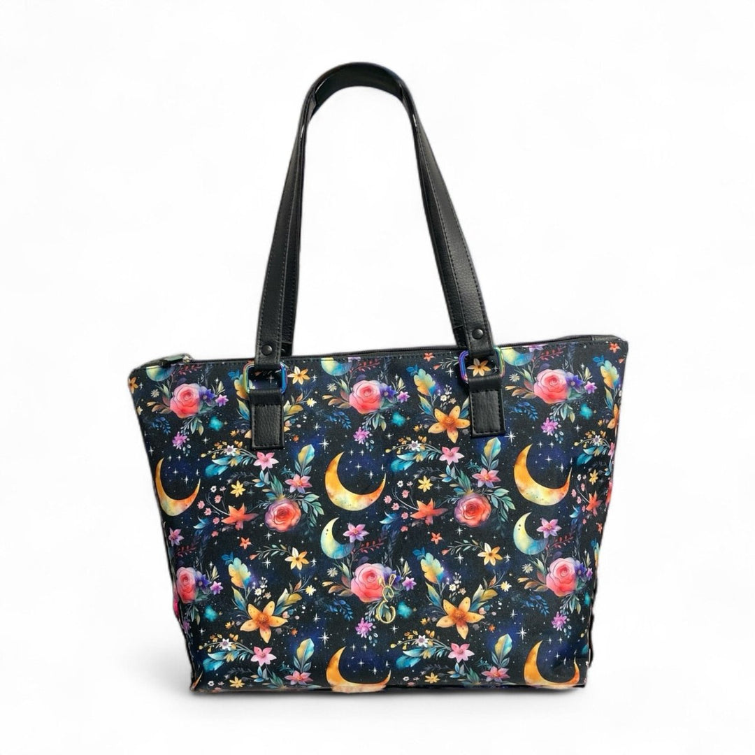 Mystic Garden handmade tote bag with celestial floral print and black handles, roomy and fully lined with water-resistant fabric.