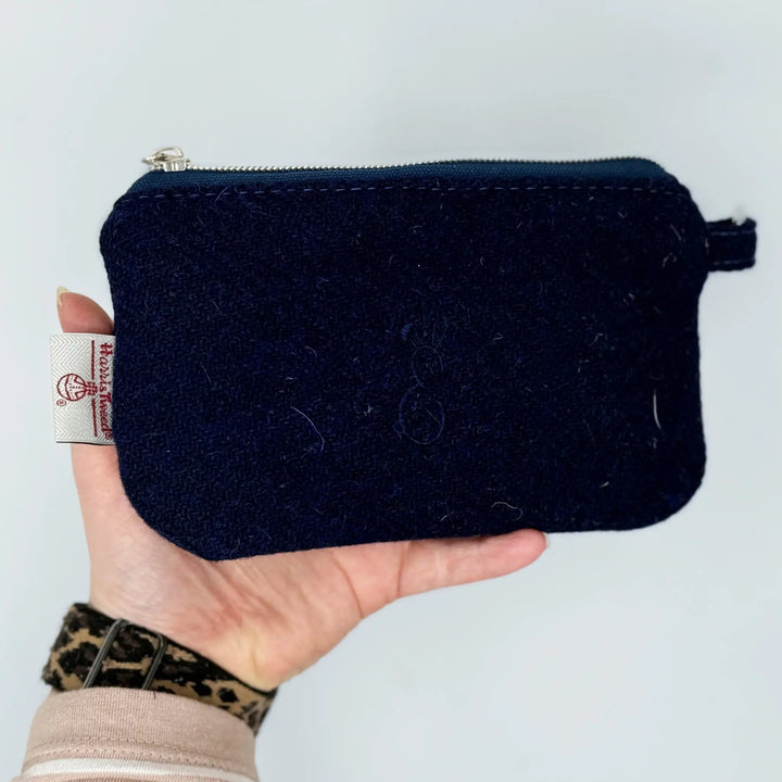 Navy blue Harris Tweed® pouch held by a hand by Emma Easter Handcrafted and made in Wales