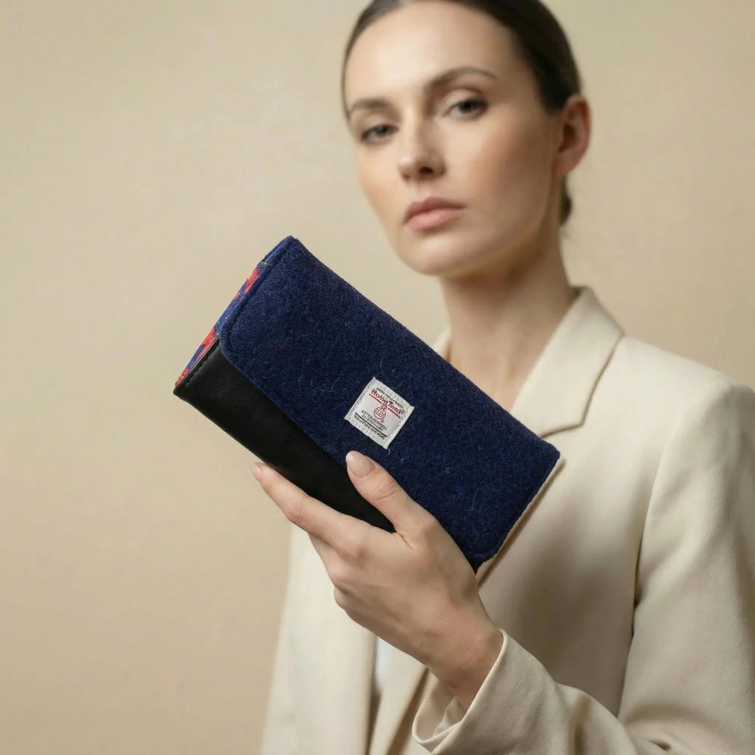 Model holding Navy Poppy leather purse with Harris Tweed® exterior flap