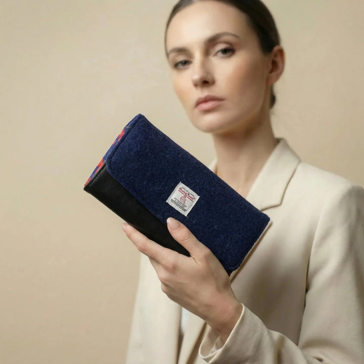 Model holding Navy Poppy leather purse with Harris Tweed® exterior flap