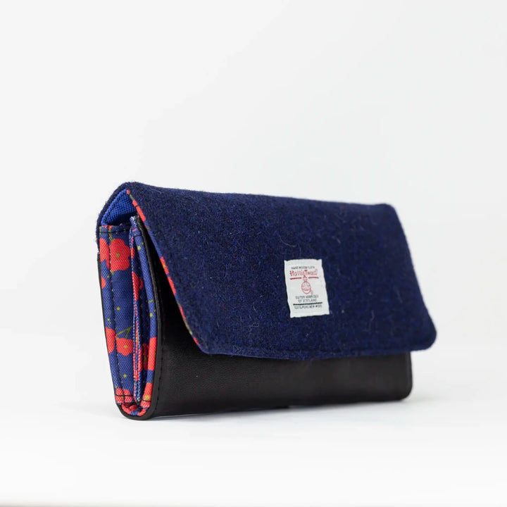 Angled view of Navy Poppy leather purse featuring an authentic Harris Tweed® exterior flap