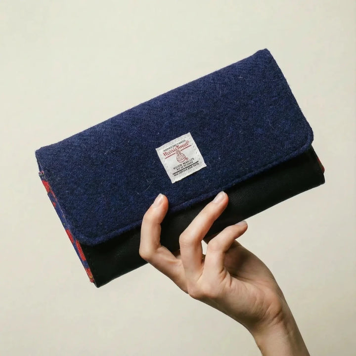 Navy Poppy leather purse with Harris Tweed® exterior flap shown held in hand