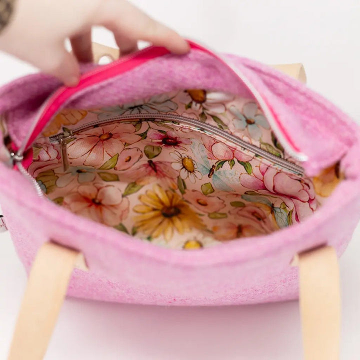 Interior of the Penelope Harris Tweed pink tote bag with floral water-resistant lining and zip pocket.