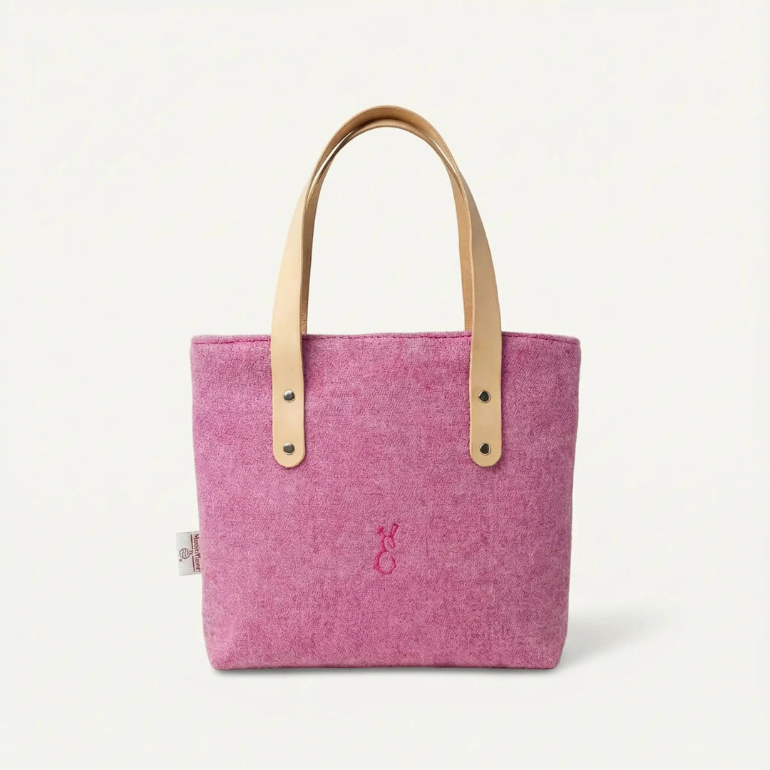 Front view of the Penelope Harris Tweed pink tote bag with natural leather handles, handcrafted in Wales by Emma Easter