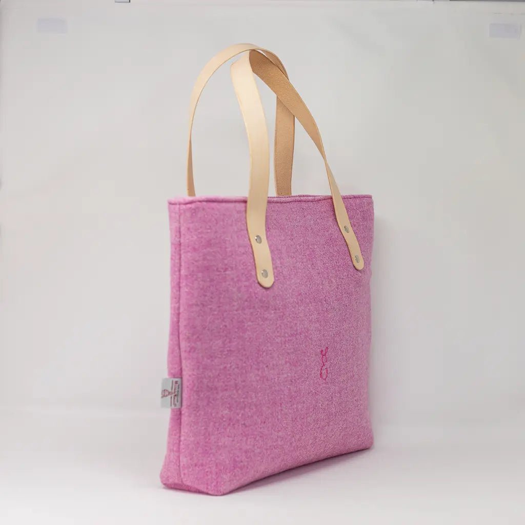 Angled side view of the Penelope Harris Tweed pink tote bag with leather handles by Emma Easter Handcrafted