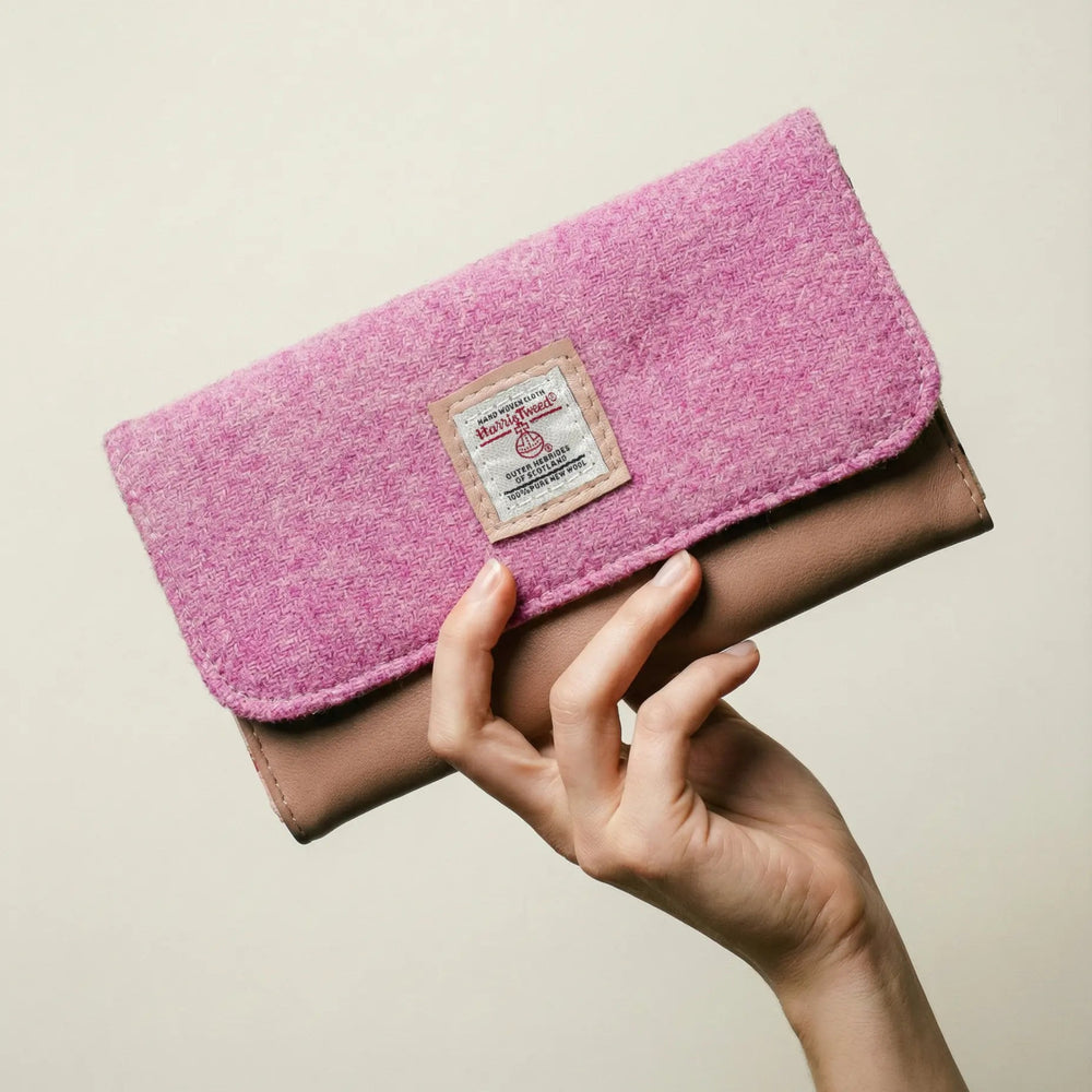 Hand holding Penelope Harris Tweed® and leather purse, handcrafted in Wales