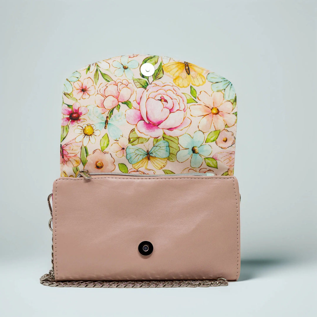 Floral-patterned clutch with a pastel pink leather base by Emma Easter handcrafted
