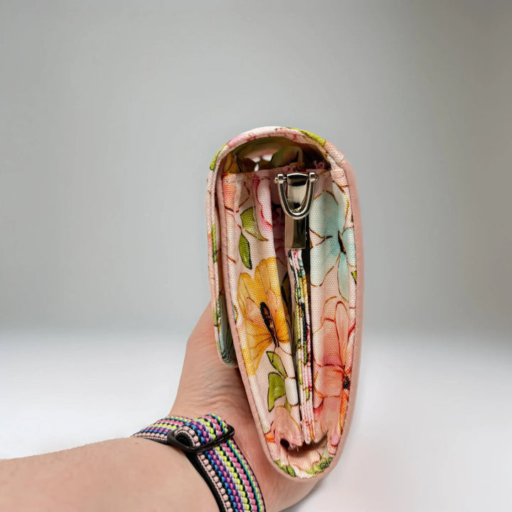 Floral-patterned pink Penelope leather clutch bag with silver coloured hardware side view made in Wales by Emma Easter Handcrafted