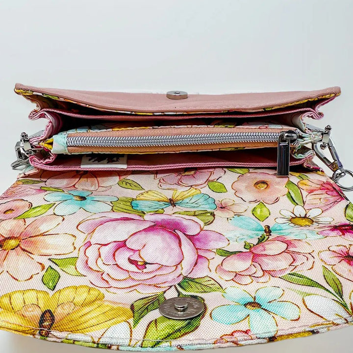 Floral-patterned clutch bag with a silver chain on a light gray background