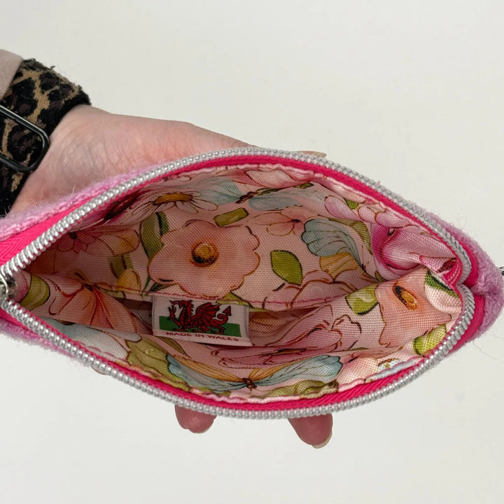 Pink Harris Tweed® Cloth Floral-patterned pouch made in Wales held by a hand against a white background