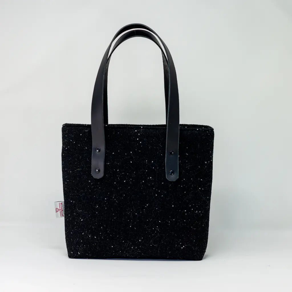 Alternative front view of the black Harris Tweed tote bag, handcrafted with black leather handles by Emma Easter Handcrafted.