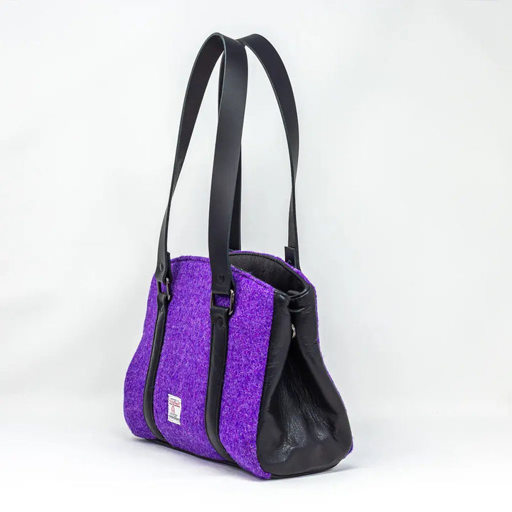 Side view of the Rowena Harris Tweed® purple handbag with black leather detailing, handcrafted in Wales.
