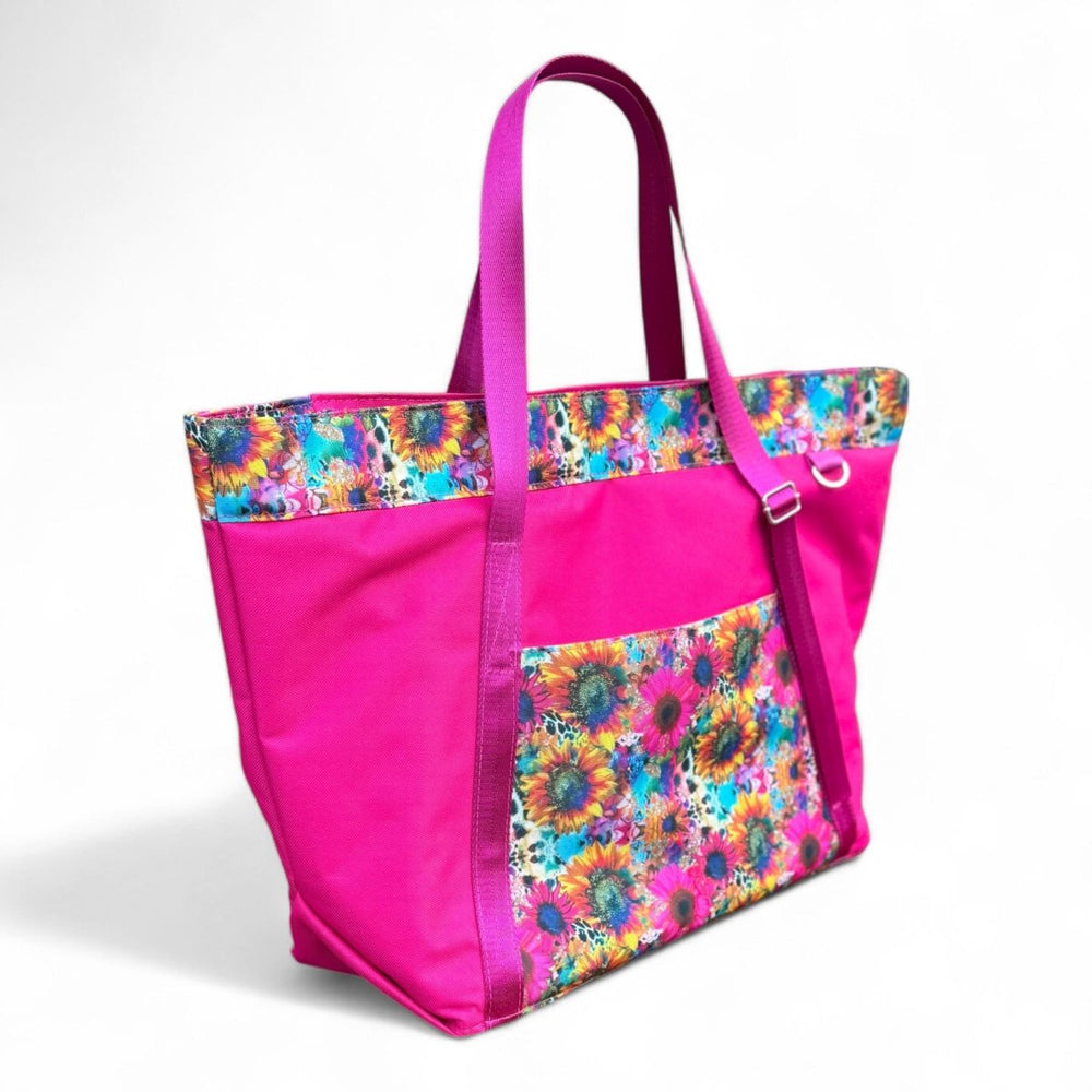 Side view of the Summer Burst tote bag, showcasing pink body, floral panels, and roomy design. Ideal for summer adventures. Handcrafted in Wales.