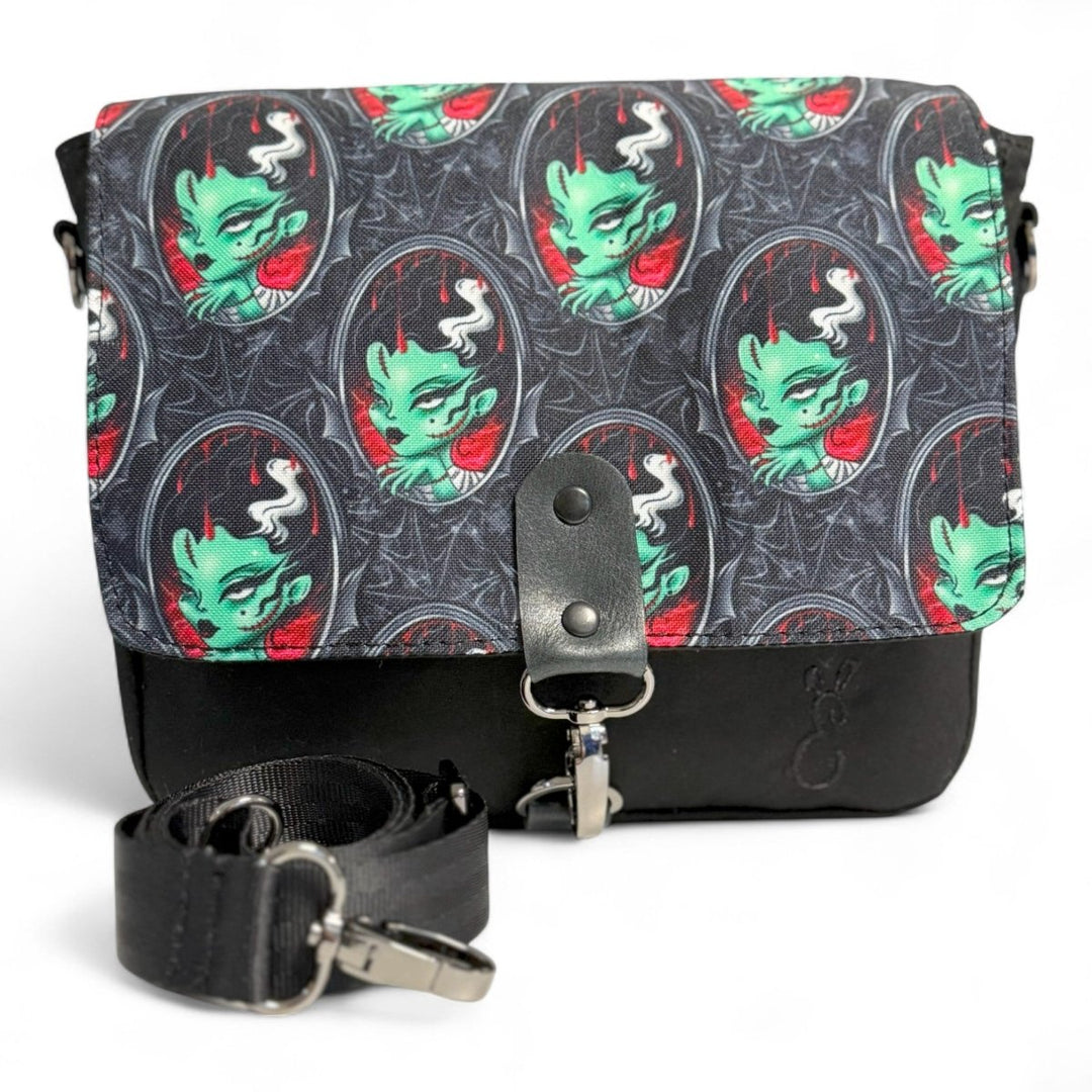  Crossbody bag featuring a gothic green zombie bride print, handcrafted in Wales with leather details. A bold, quirky choice for alternative fashion fans.